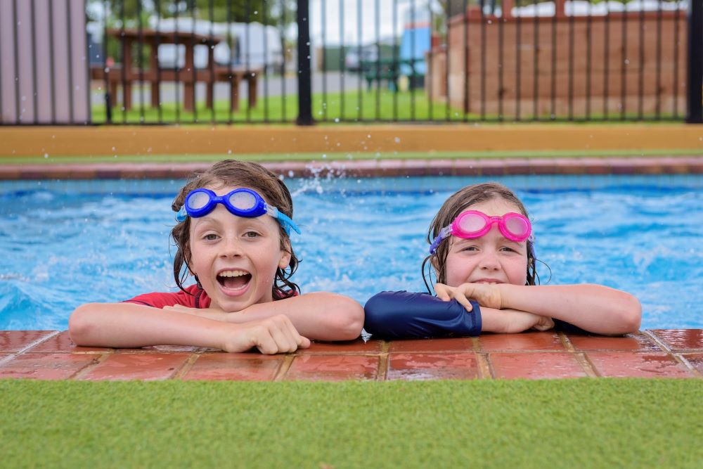 Two children holding onto the edge of Adelaide Beachfront outdoor pool